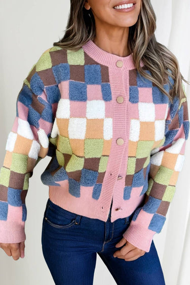 Women’s colorful checkered cardigan sweater with pink trim and button front – cozy fall fashion.
